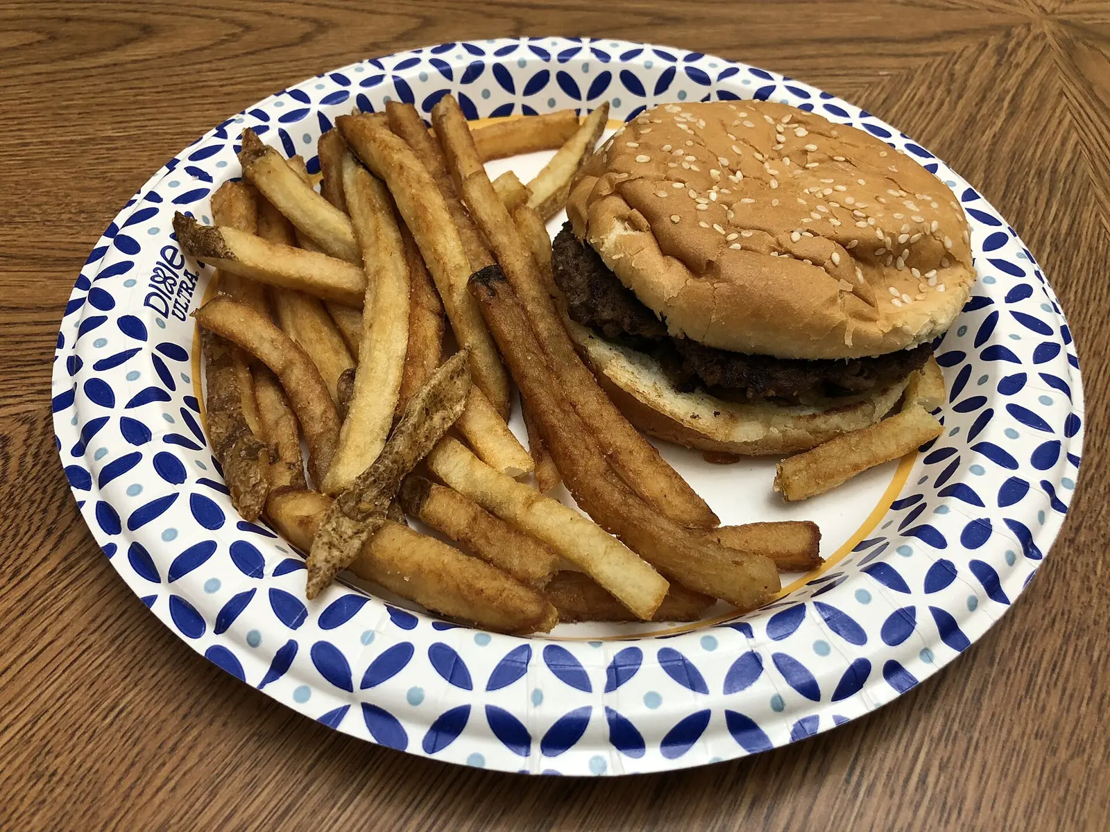 A hamburger and french fries on a paper plate from Five Guys in the Franklin Farm section of Oak Hill, Fairfax County, Virginia