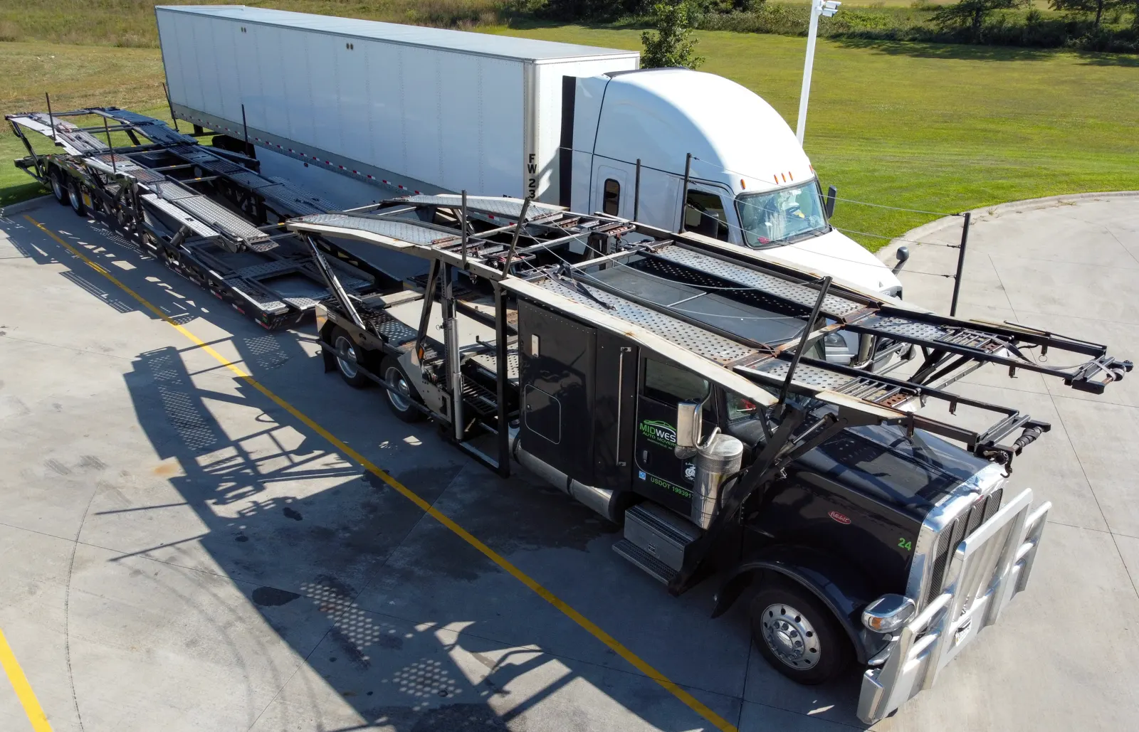 A second view of an open car-carrier trailer