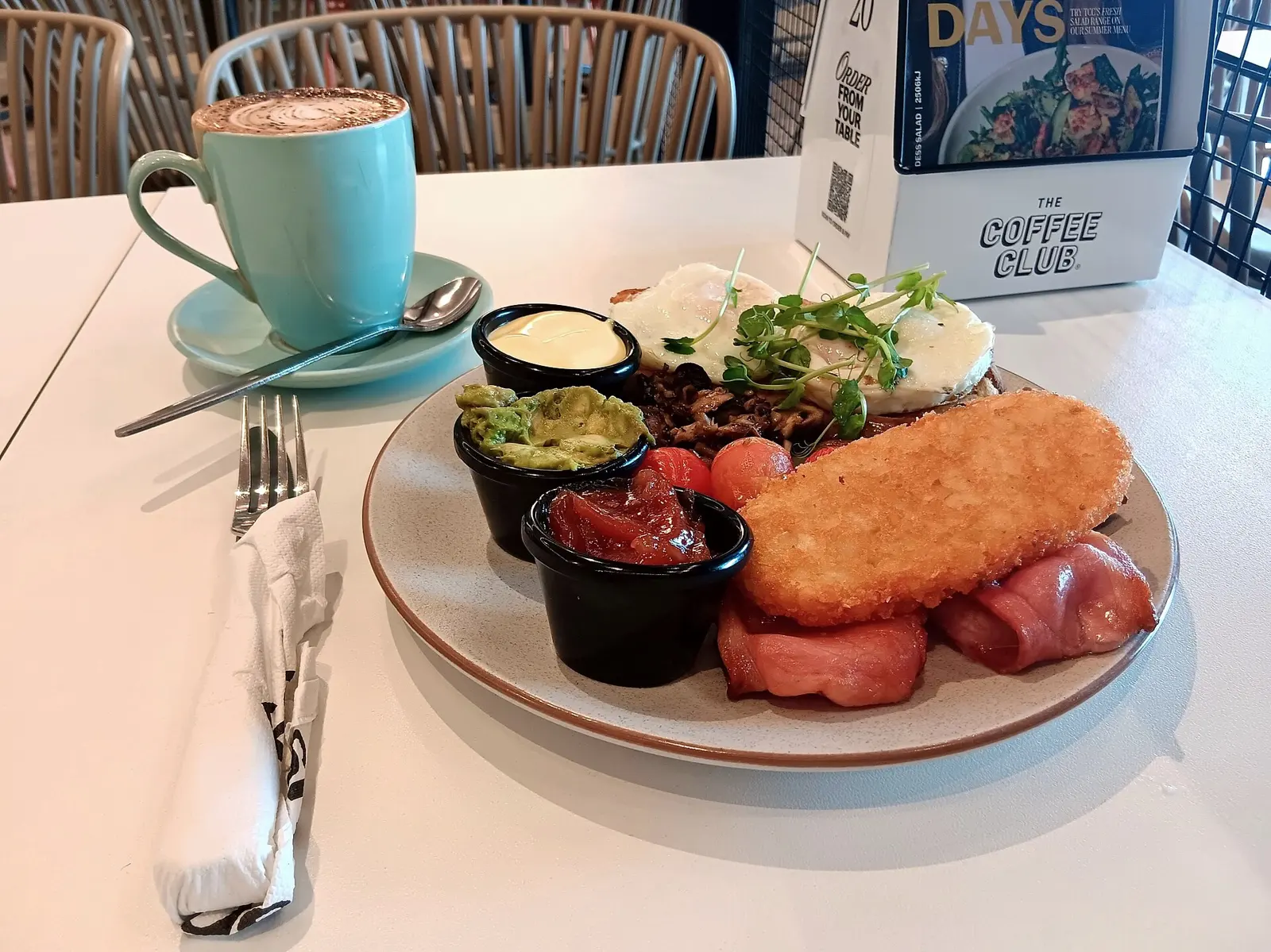 Club Big Breakfast with large cappucino, The Coffee Club Riverton: described as 'Eggs, bacon, mushrooms, chipolatas, freshly smashed avo, hash brown, confit cherry tomatoes,...