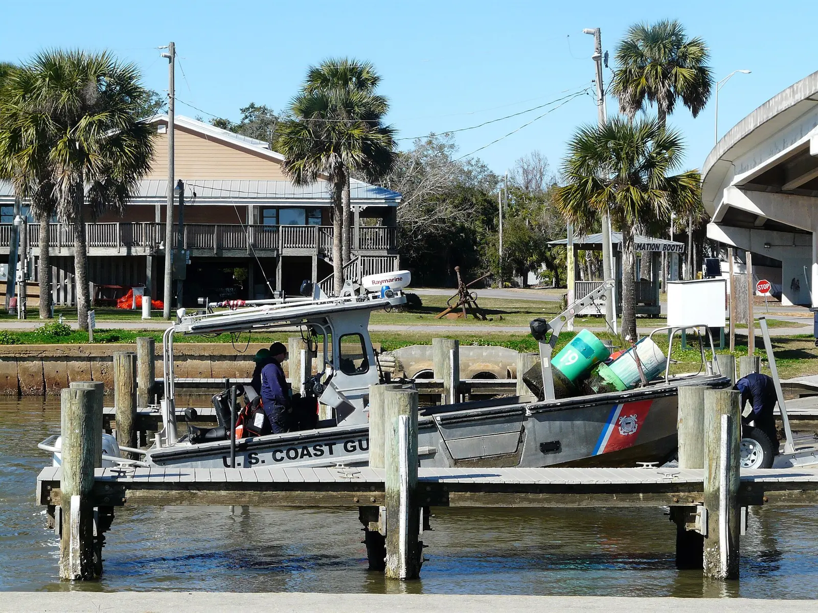 A Aids to Navigation Boat of the United States Coast Guard is loaded aboard a trailer in the marina at Battery Park in Apalachicola, Florida . This may be boat 26133.
