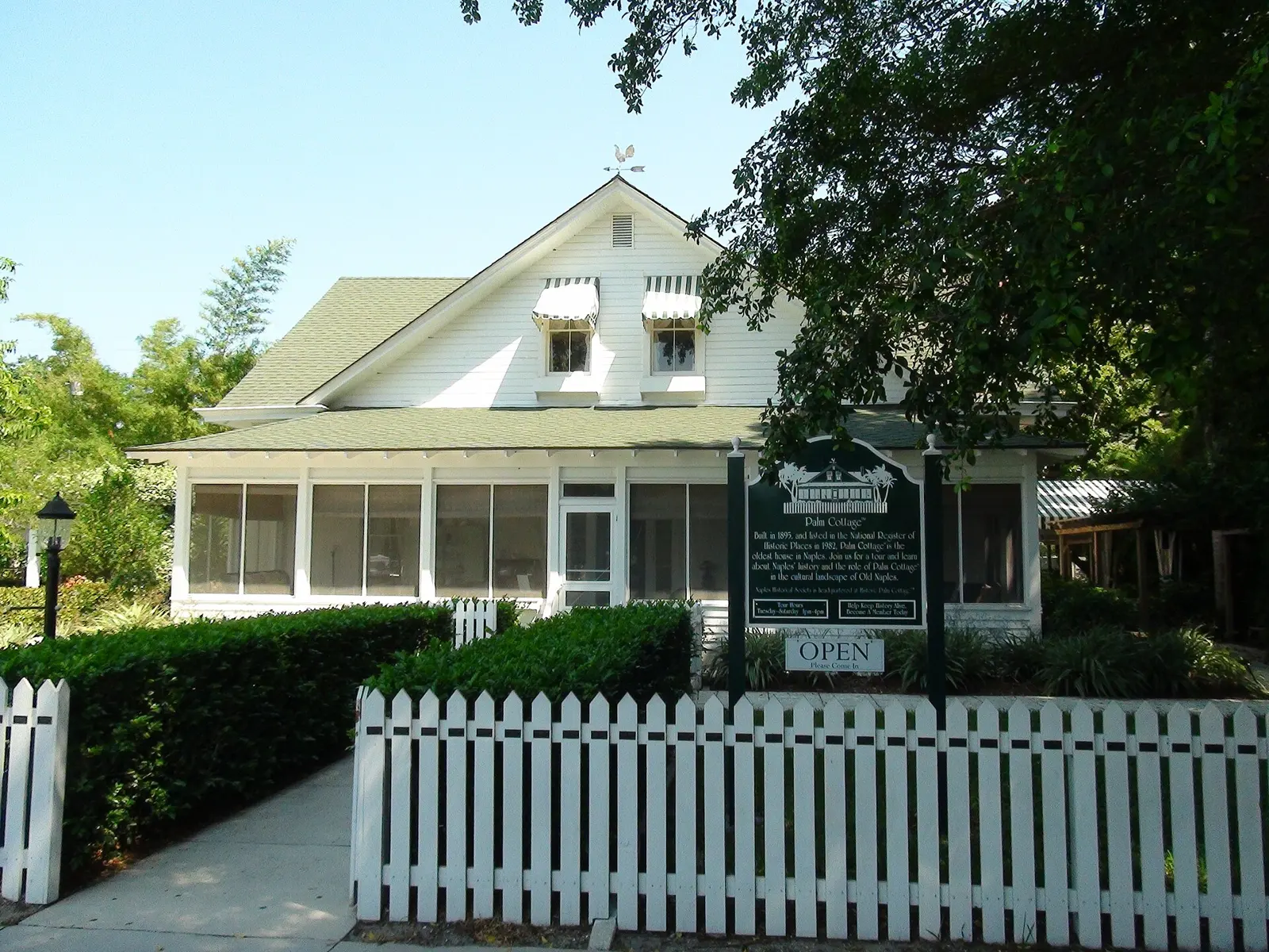 Exterior with plaque and fence. 137 12th Ave. South, Naples, FL.
