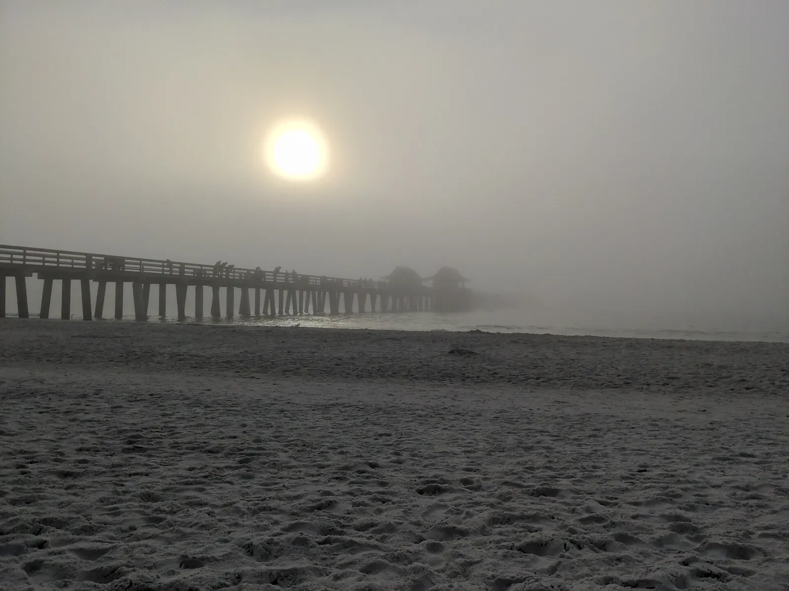 The pier of Naples in the fog