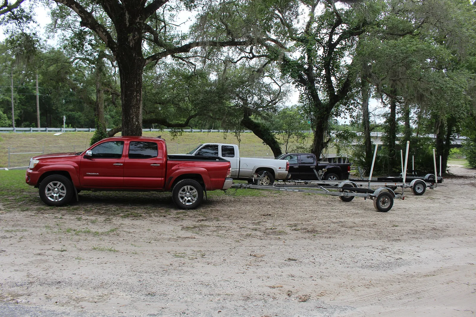 Trucks and boat trailers at a Florida public ramp parking lot